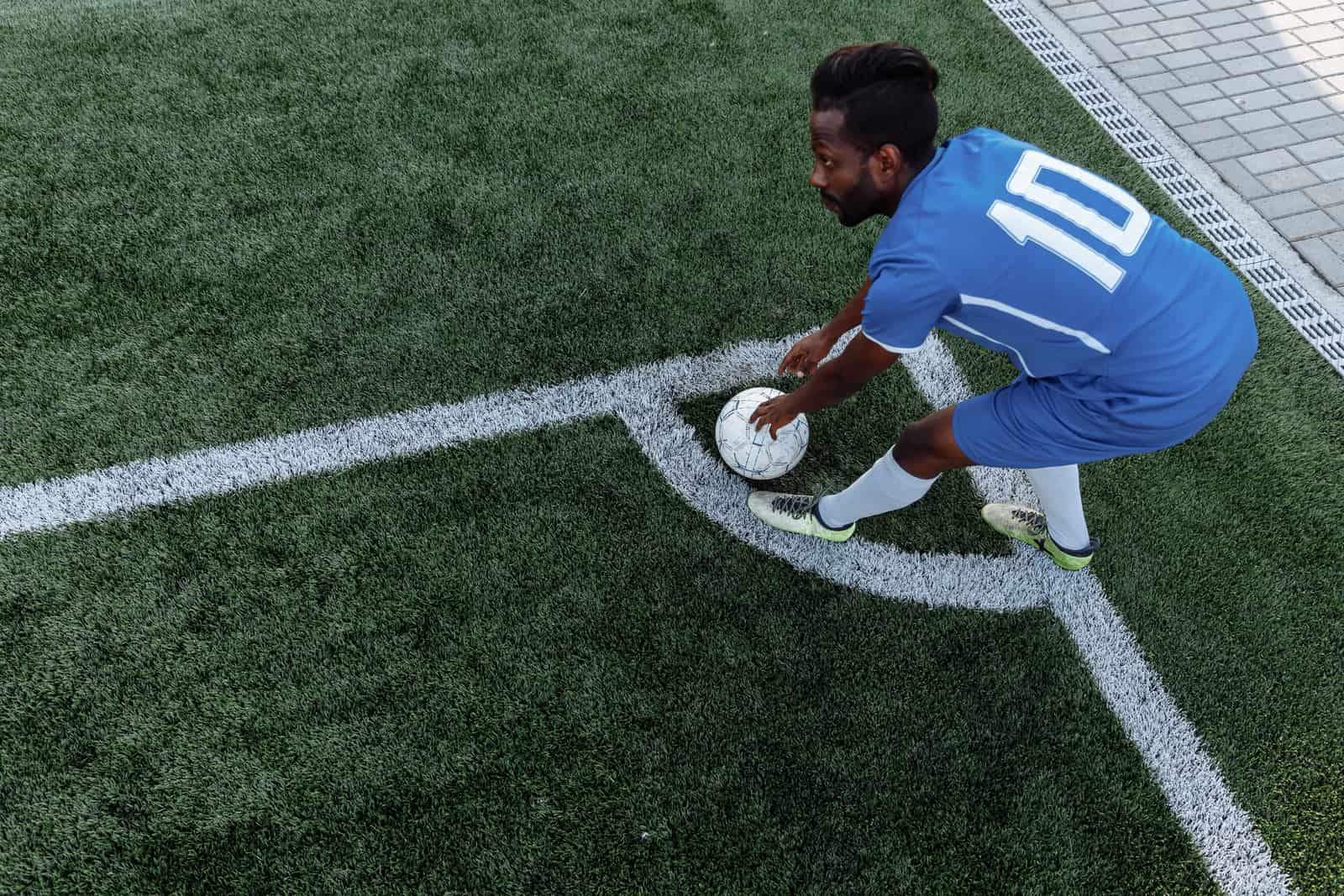A player's shoes on an artificial turf soccer field