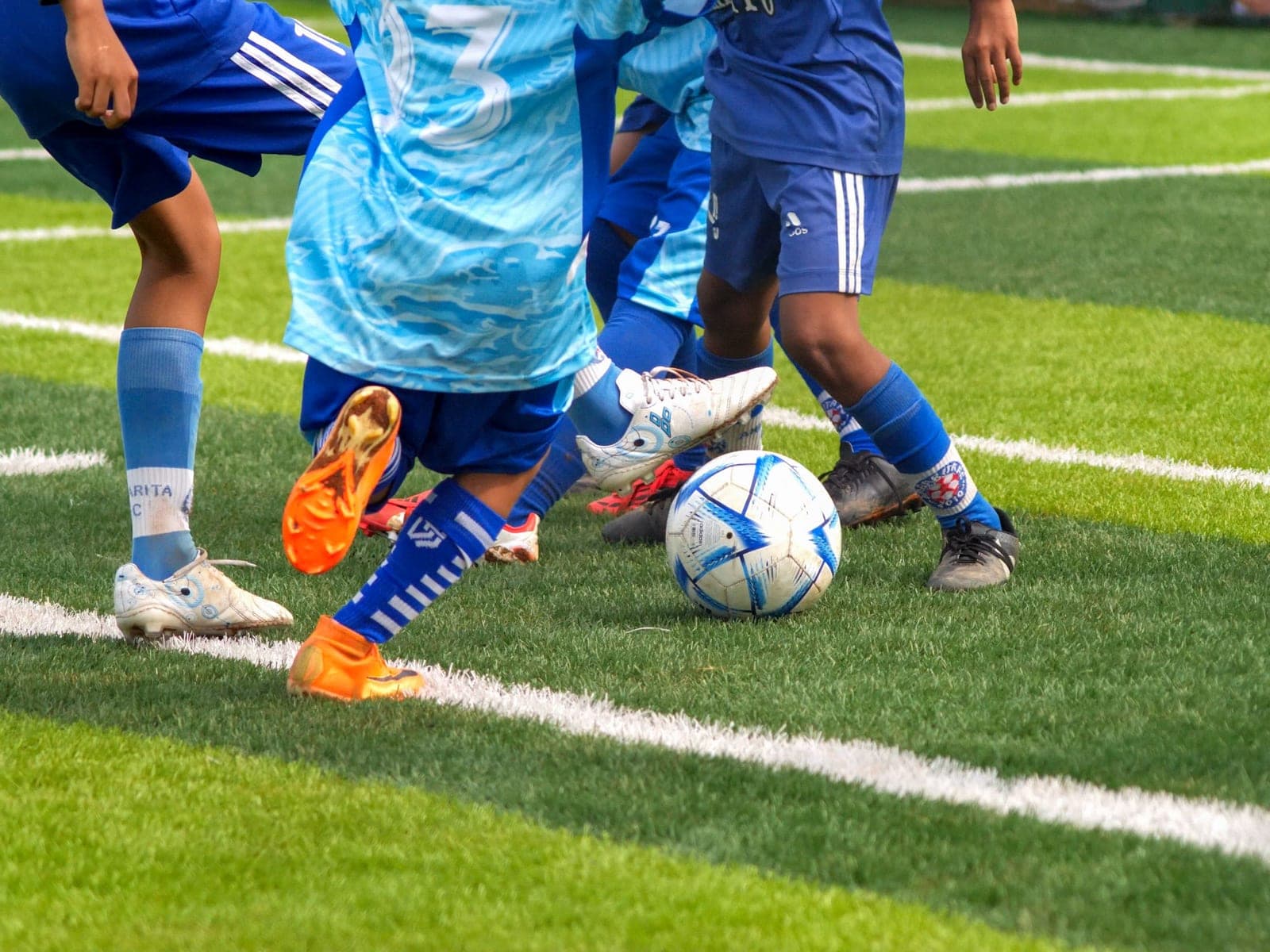 Children playing a youth soccer game on a grass field