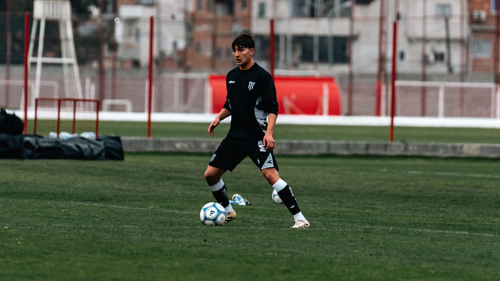 A teenage soccer player on a pitch