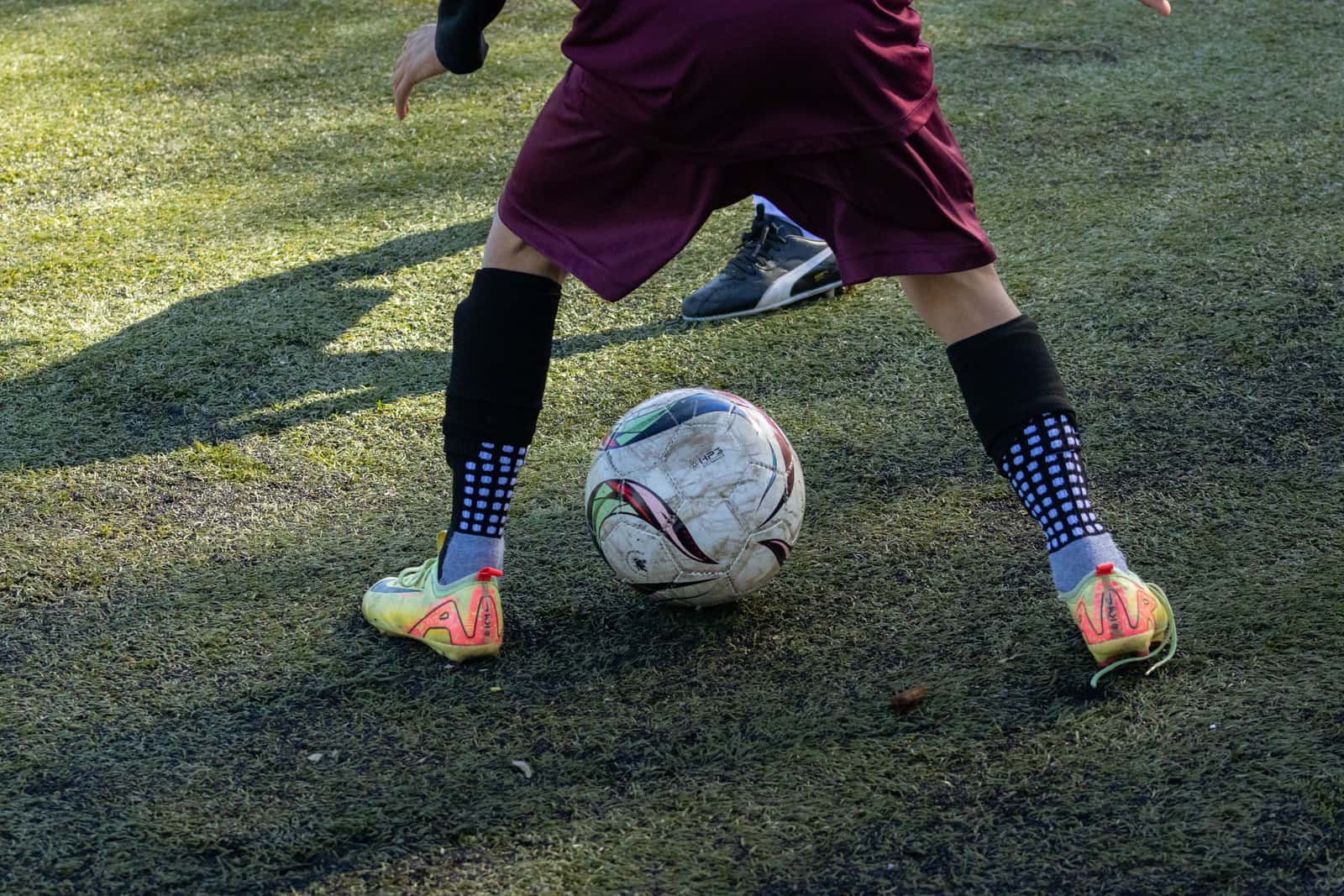 Youth soccer socks and shin guards laid out together